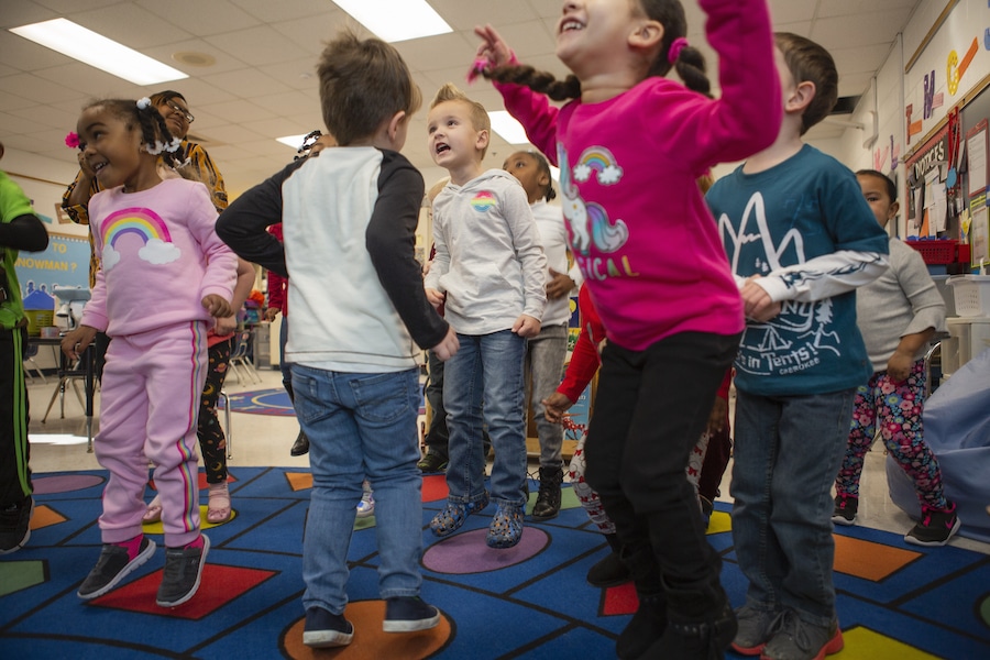 children jumping together in the classroom