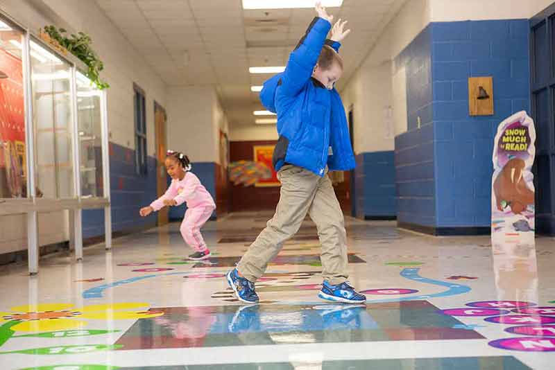 Boy and girl jumping and hopping