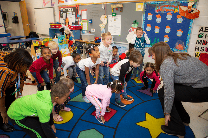 A group of children touching toes