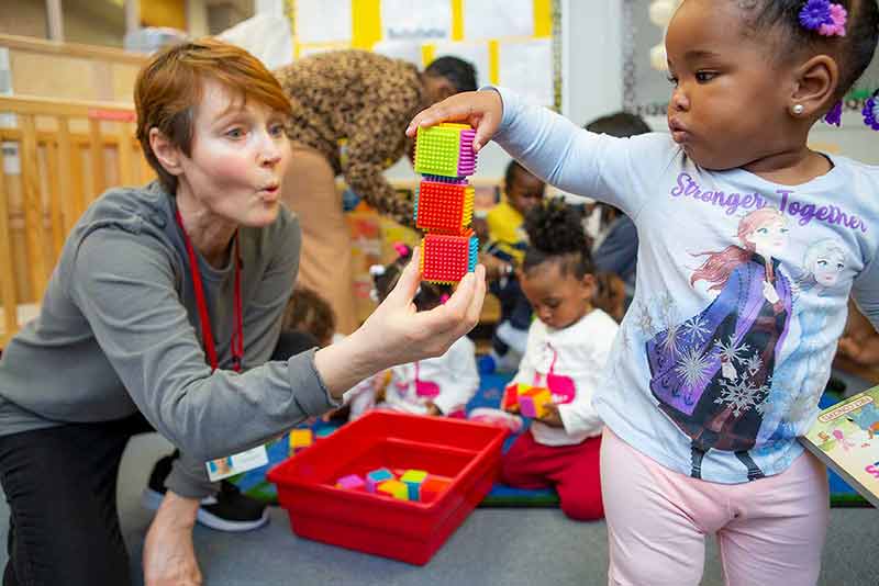 child stacking cubes