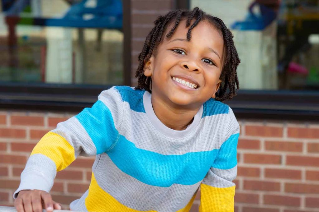 A young boy smiling on the playground